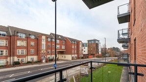 A residential street with brick houses, a clear road, and a pedestrian crossing. - Stylish 2BR Apartment | Stay Zeni, Ouse Court York (York)