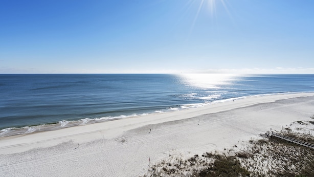 A beach with a clear sky and the sun shining. - White Caps 1202 by Liquid Life (Orange Beach)
