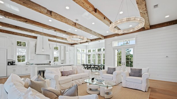 A spacious living area with white furniture, a glass coffee table, and a wooden ceiling. - Private Neighborhood beach access, large pool, golf cart, walk to beach/dine (Santa Rosa Beach)