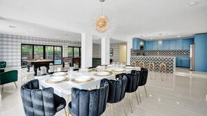 A modern dining area with a pool table, a pool, and a kitchen with blue cabinets. - Modern Luxe Design, 4K SF  Pool 5 Min to Beach (Hollywood)