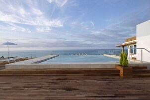 Una piscina al aire libre de temporada, sombrillas