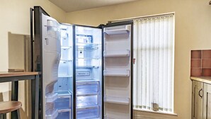 A kitchen with a built-in refrigerator, a window with blinds, and a tiled floor. - Fab Tree-Lined, Upmarket Area | Next to Queens Uni - Pass the Keys (Belfast)