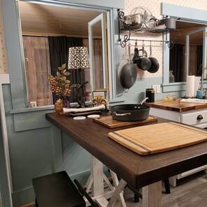 A kitchen with wooden countertops, a cutting board, a frying pan, and hanging pots. - Relaxing country setting perfect for that special get away!! (Beatrice)