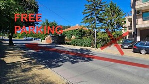 A street with a building on the right and a car parked in front. - If you want romance - the right place for you is Balchik, apartment Vista! (Balchik)