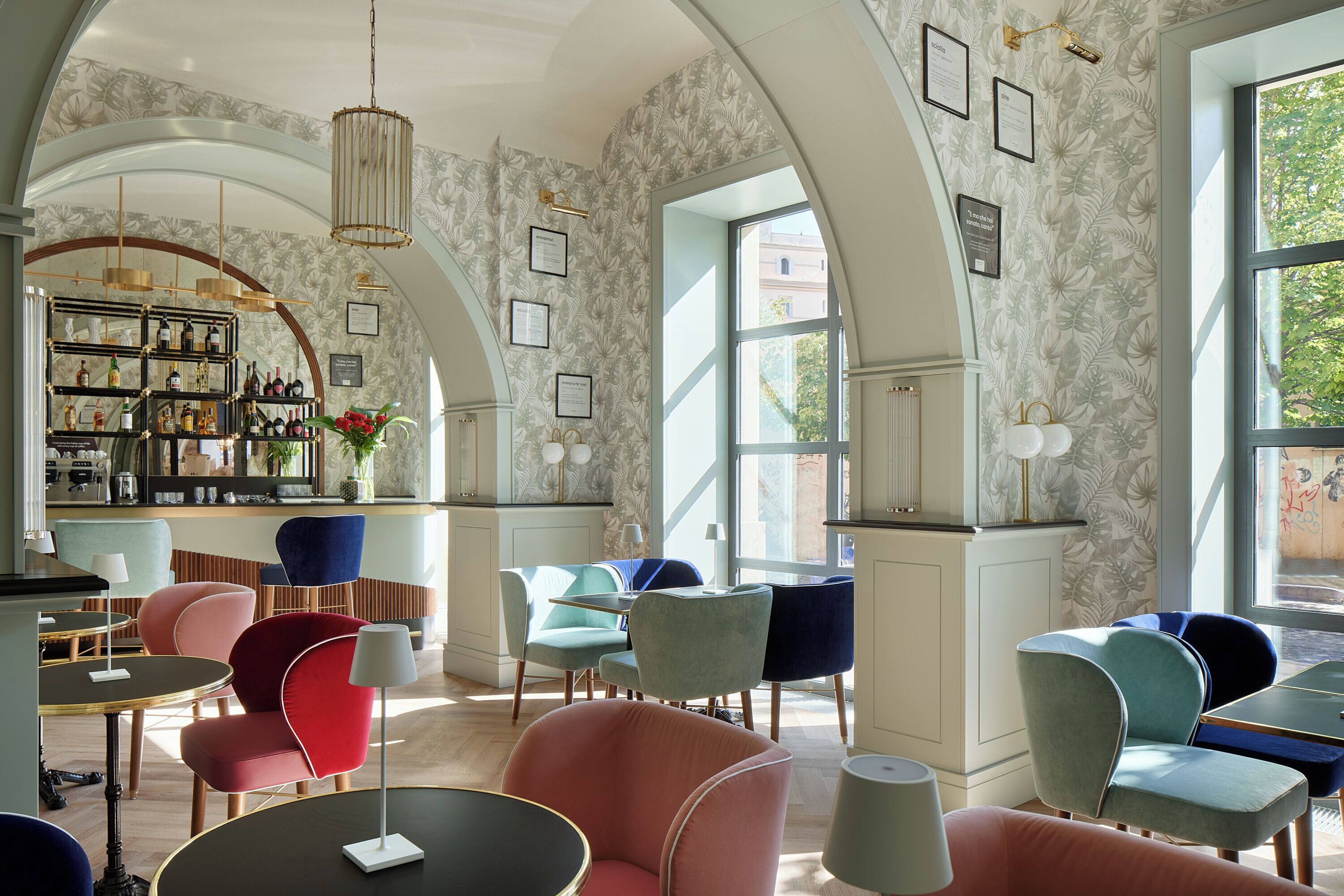 A spacious lounge area with a bar, comfortable seating, and large windows offering natural light.