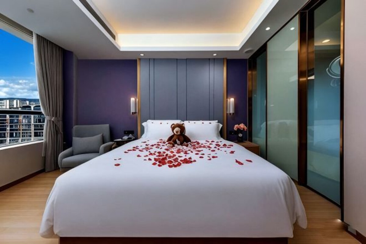 A hotel room with a large bed, a chair, a nightstand, and a view of the city.