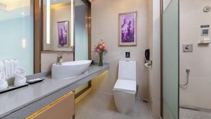 A modern bathroom with a large mirror, a white sink, a toilet, and a shower area. - Lavande Hotel (Shenzhen Airport Fuyong Metro Station) (Shenzhen)