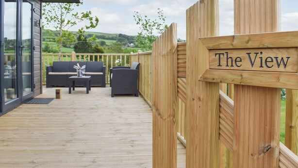 A wooden deck with a sign reading "The View," outdoor furniture, and a scenic landscape in the background. - 3 bedroom accommodation in Barrow, near Clitheroe (Barrow, near Clitheroe)