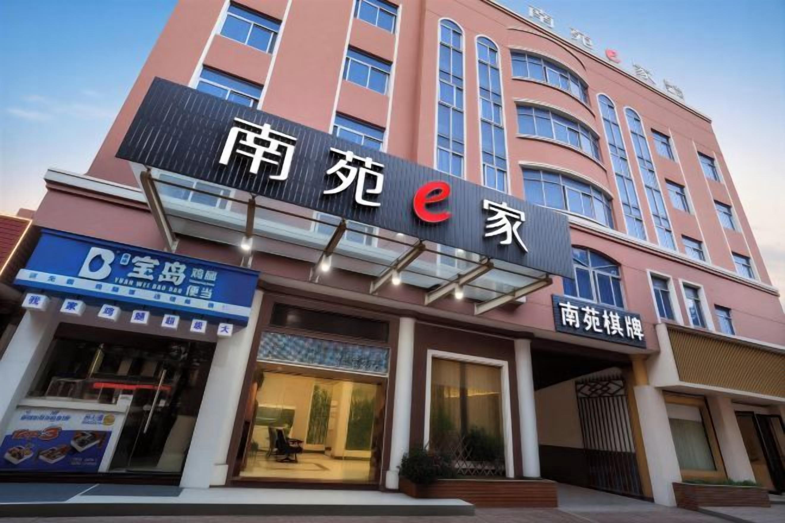 A hotel with a prominent sign reading '南苑e家' and a smaller sign below it.