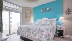A bedroom with a bed, two bedside tables, a window, and a view of the outside. - HS-0813 Ocean View 2-Bedroom Condo in Myrtle Beach (Myrtle Beach)