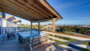 A wooden deck with a pool, overlooking a residential area. - Surf Chalet w/ hot tub and kayaks (Avon)