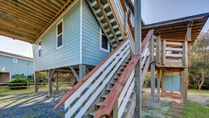A house with a wooden deck and a staircase leading to a second level. - Surf Chalet w/ hot tub and kayaks (Avon)