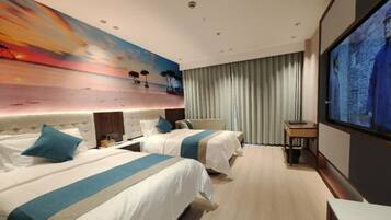 A hotel room with two beds, a large painting of a sunset, a television, and a view of the sea through the window.
