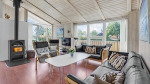 A cozy living room with a fireplace, comfortable seating, and large windows. - Stunning home in Sydals with sauna (Sydals)
