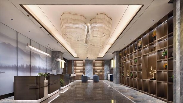 A modern hotel lobby with a reception desk, seating area, and a wall with decorative items. - Tianhai International Hotel (Changsha Gaoxin District Meixi Lake park) (Changsha)