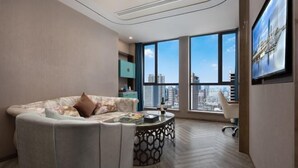 A modern living room with a sofa, coffee table, and a large window with a city view. - Tianhai International Hotel (Changsha Gaoxin District Meixi Lake park) (Changsha)
