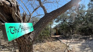 A sign on a tree reading "The Hideaway".