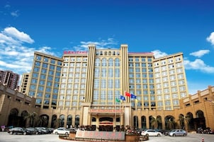 Un gran hotel con varios pisos y una entrada principal.