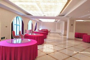 A conference room with round tables, chairs, and large windows. - Anfu Jiangjing Hotel (Anfu)