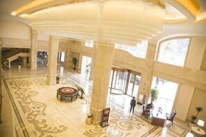 A spacious lobby with high ceilings, large columns, and a central seating area. - Anfu Jiangjing Hotel (Anfu)