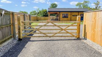A wooden gate leading to a building with a sign reading "AYLESBURY."