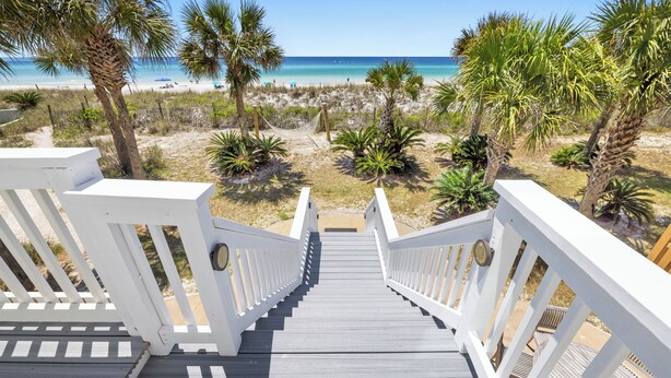 A wooden staircase leading to a beach with palm trees and a clear view of the ocean. - 5 STAR BEACH FRONT RENOVATED TOWNHOME with BEACH SERVICE on Okaloosa Island (Fort Walton Beach)