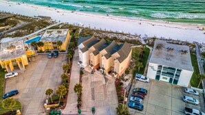 An aerial view of a coastal hotel with a parking lot, beach access, and a pool area. - 5 STAR BEACH FRONT RENOVATED TOWNHOME with BEACH SERVICE on Okaloosa Island (Fort Walton Beach)