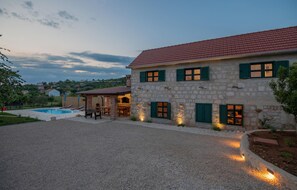 A stone building with a red-tiled roof, a pool, and outdoor seating. - Lovely home in Glavina donja (Glavina donja)