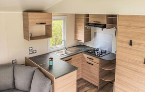 Fridge, stovetop, dishwasher, coffee/tea maker