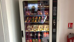 A vending machine with snacks, drinks, and cigarettes.