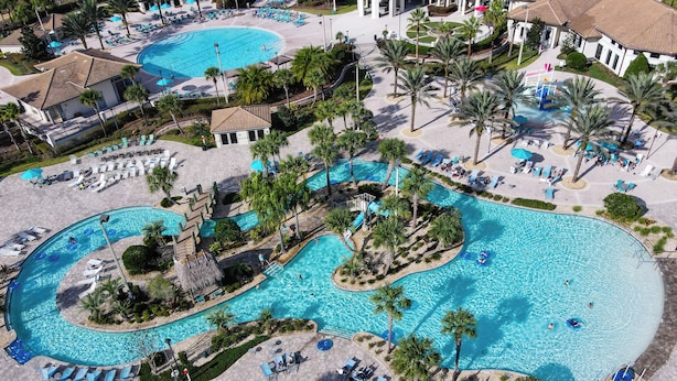 An aerial view of a resort with multiple swimming pools, palm trees, and lounge areas. - Imperial Retreat: Games,Pool,Theatre + Free Night (Champions Gate)