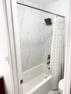 Combined shower/tub, hair dryer, towels, soap