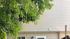 A patio area with a sofa, a bench, and a table with chairs. - Townhouse on Strand...Centrally located with all new furnishings and Central AC (Missoula)