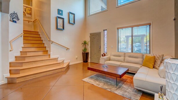A spacious living area with a staircase, a sofa, and a coffee table.
