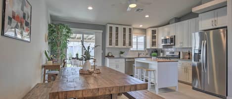 Enjoy cooking and dining in this kitchen with a central island, dining area, and ample storage.