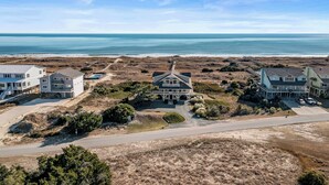 A coastal property with multiple buildings, a beach view, and a road leading to the beach. - "All Hands On Deck" Oceanfront with elevator 5 bedrooms, 5 bathrooms. (Holden Beach)