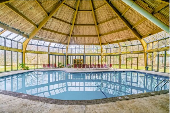 Relax by the pool surrounded by a glass enclosure and a unique architectural design.