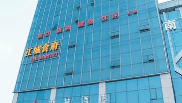 A high-rise building with multiple floors, featuring a prominent sign with Chinese characters and a phone number.