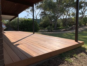 A wooden deck with a covered area, surrounded by greenery and trees. - Walking distance to Sorrento Village, Front & Back Beaches (SORRENTO)
