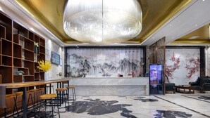 A modern lobby with a marble floor, wooden furniture, and a large chandelier. - Tingxi International Hotel (Changsha County)