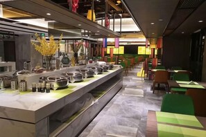 A modern restaurant with a long counter, multiple seating areas, and a variety of dishes displayed. - Maple, Longyan, Wanda Plaza (Longyan)