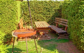 Enjoy dining and socializing around the fire pit in this garden setting.