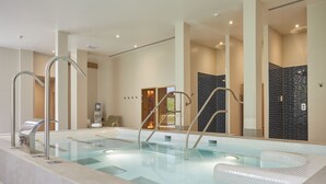 An indoor swimming pool with clear water, metal handrails, and a tiled floor. - The Retreat, Elcot Park (Newbury)
