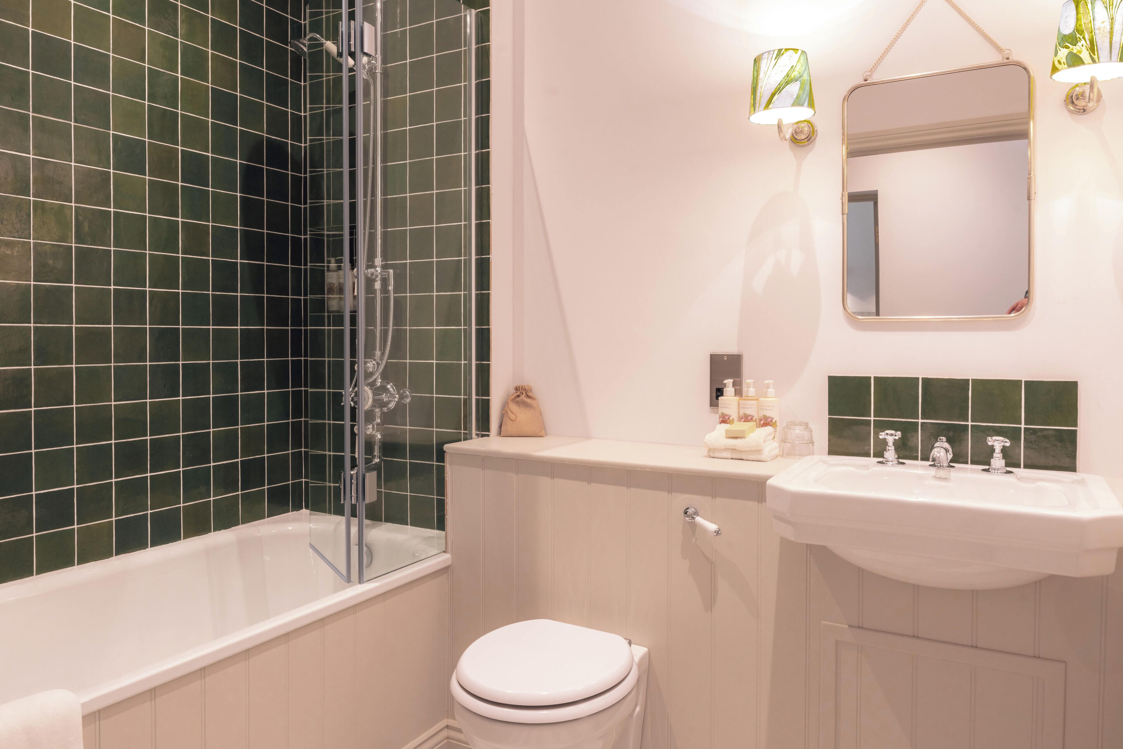 A bathroom with a bathtub, toilet, and sink.