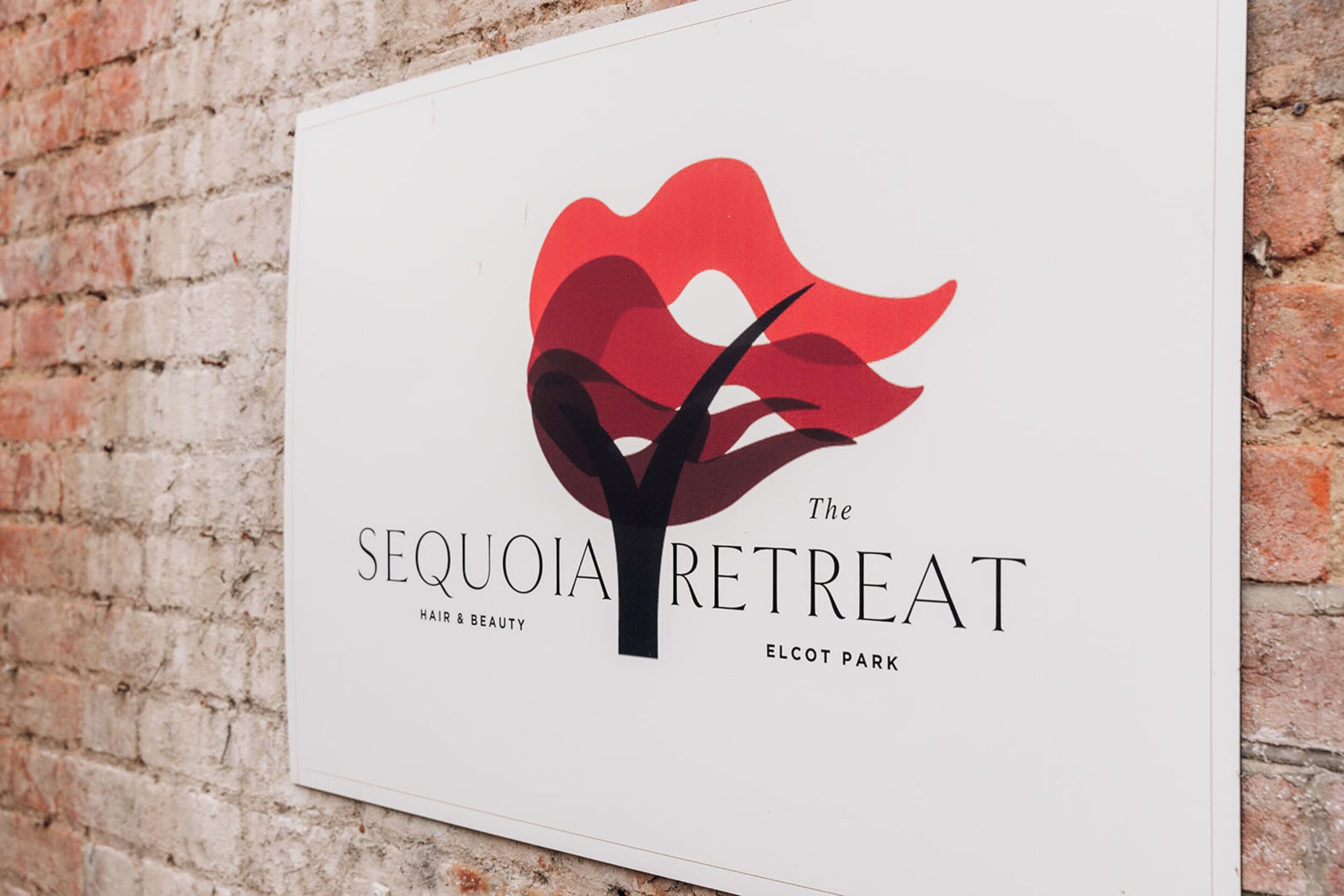 A sign for "The Sequoia Retreat" in Elcot Park, featuring a stylized tree logo.