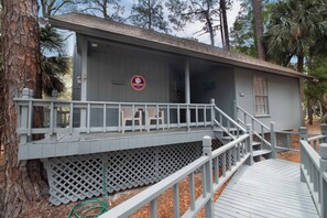 A small building with a porch and a wooden deck.