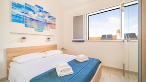 A bedroom with a bed, a window, and artwork on the wall. - Stunning home in Cornino (Cornino)