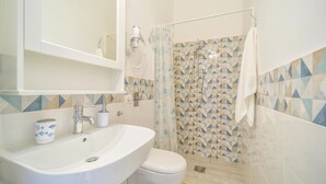 A bathroom with a sink, toilet, and shower. - Stunning home in Cornino (Cornino)