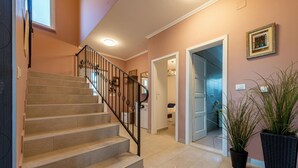 A staircase with a metal railing leading to a room with a door. - Villa Tatijana Zadarvillas (Kukljica)