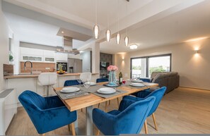 A modern kitchen with white cabinets, a wooden countertop, and a built-in oven. - Villa Nika Zadarvillas (Zadar)
